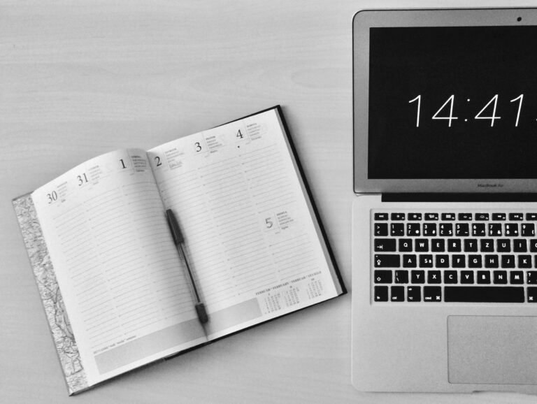 Desk setup with clock and calendar symbolizing professional time management
